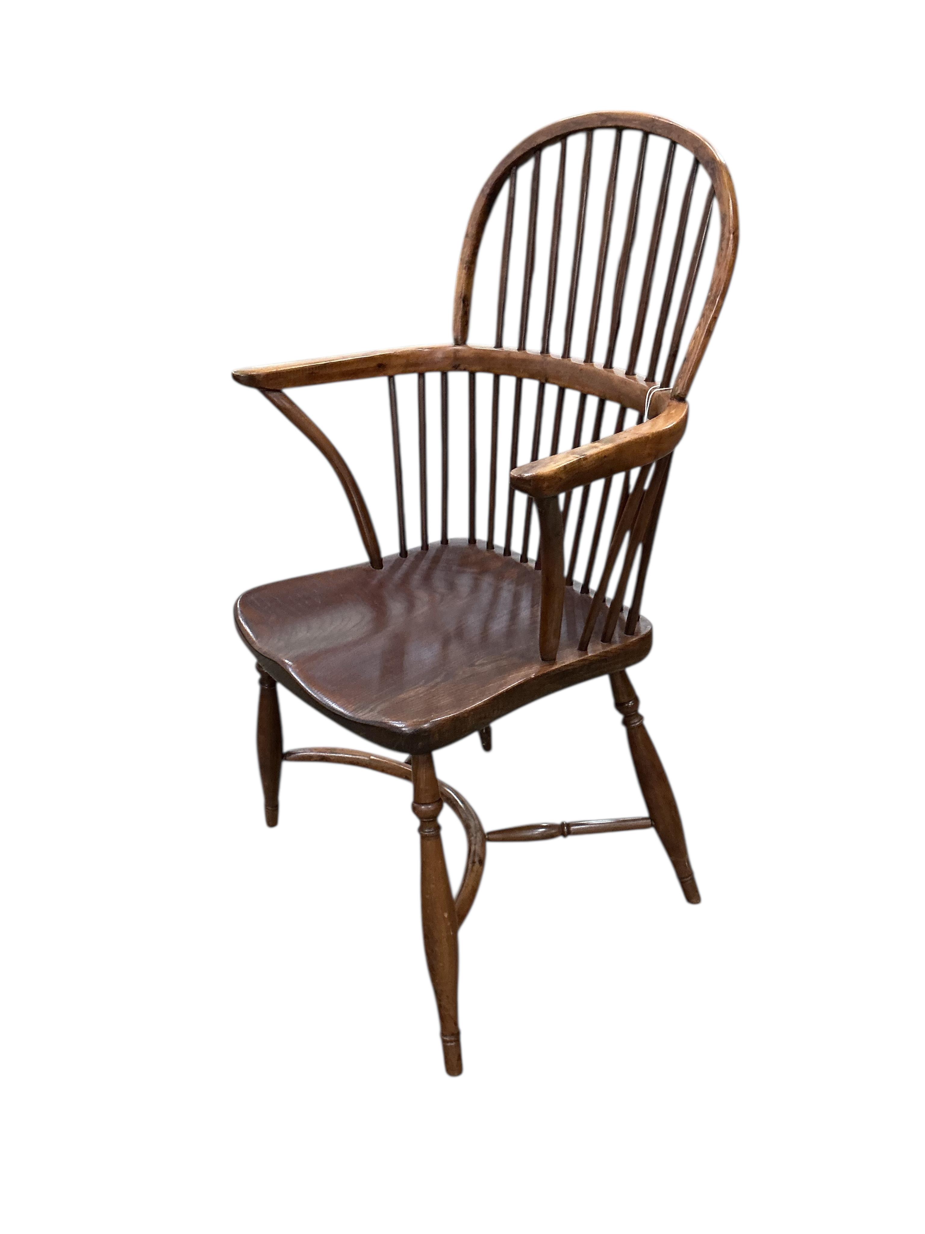 A yew and elm Windsor comb back elbow chair with crinoline stretcher, width 59cm, depth 42cm, height 96cm